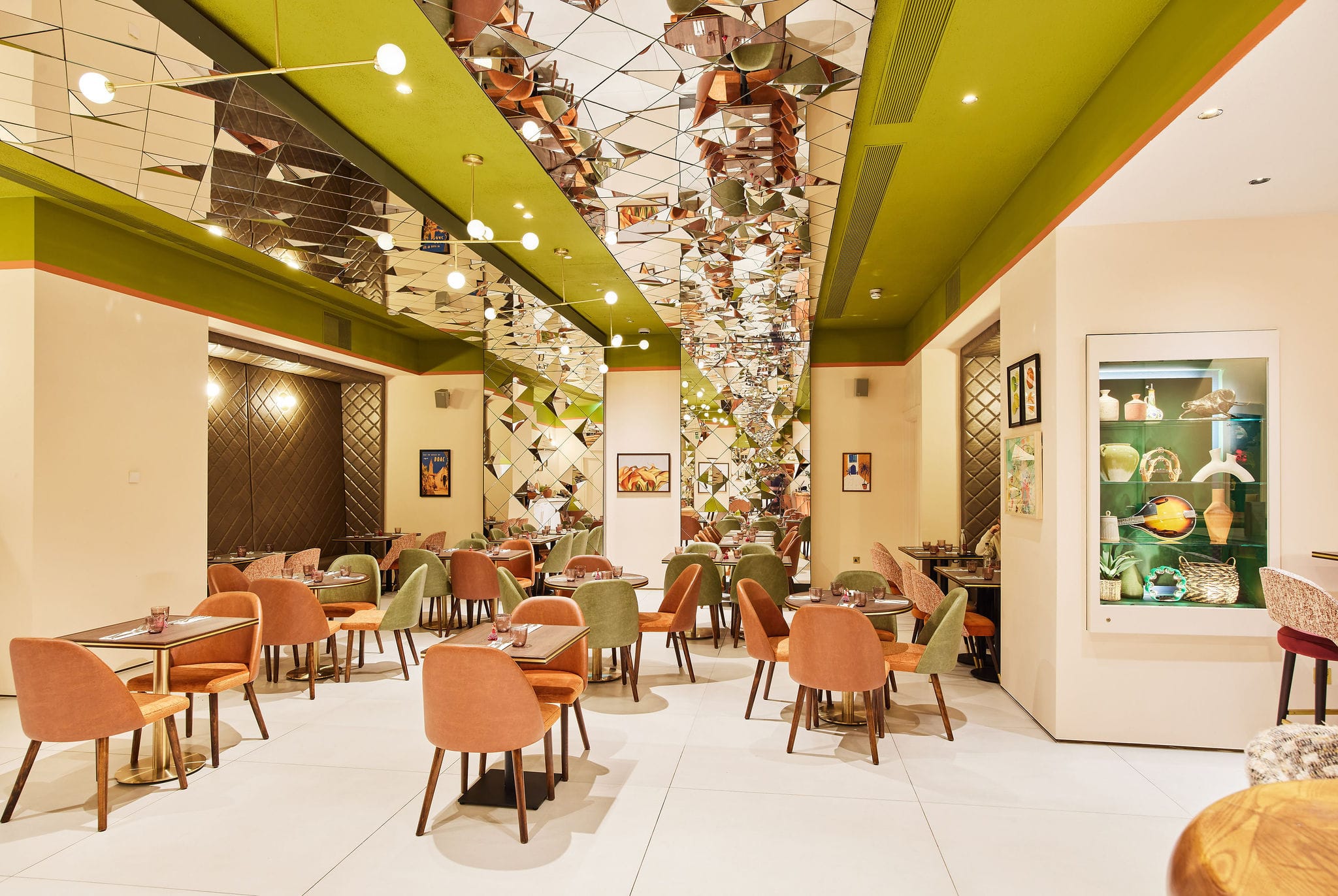 Modern restaurant with colourful chairs and mirrored ceiling