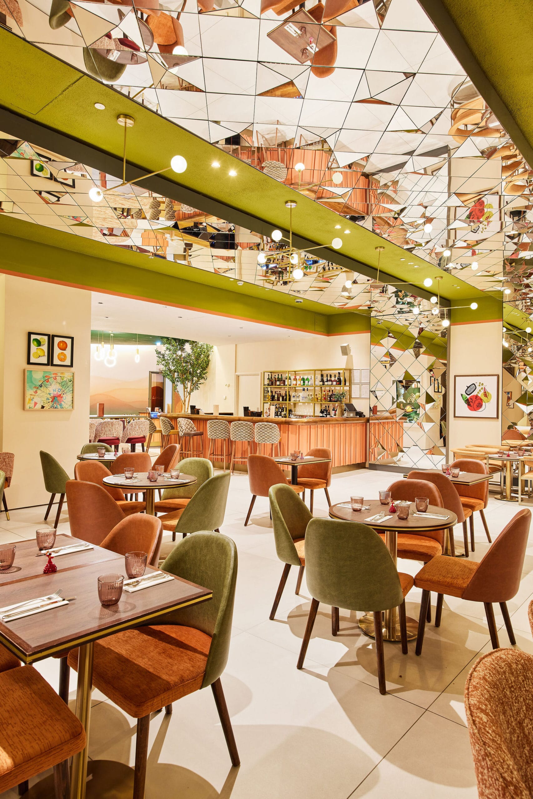 Modern restaurant interior with colourful chairs and mirrors