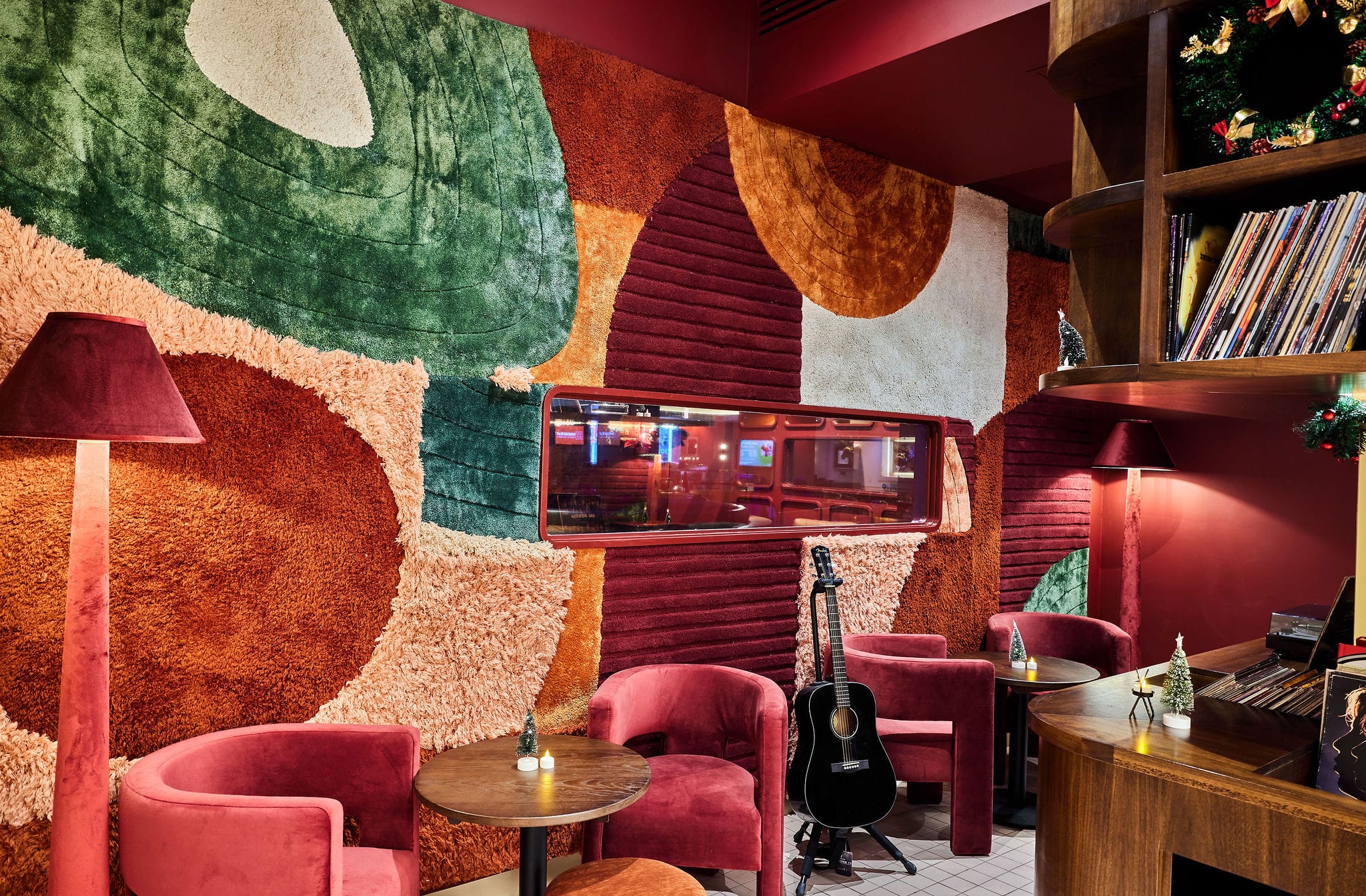 Colourful retro lounge with guitar and velvet chairs